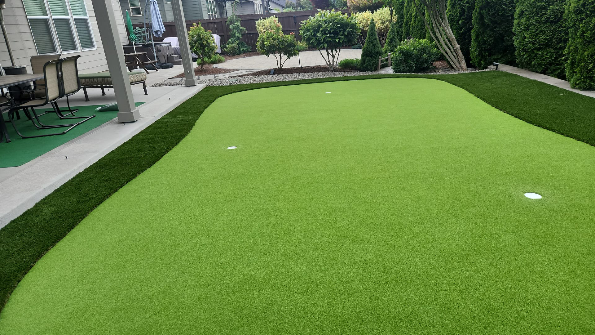 Finished backyard lawn and putting green landscape