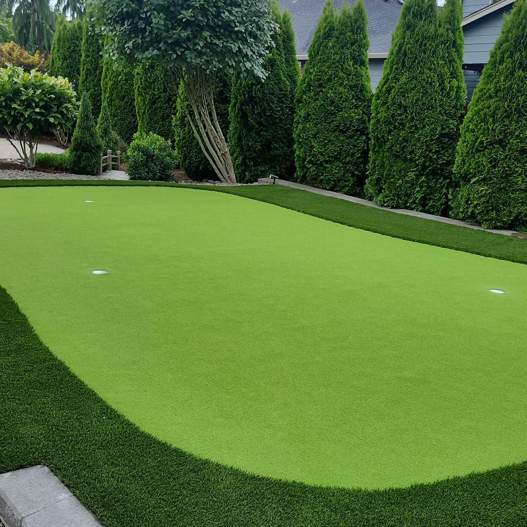 Paver patio with steps and retaining walls Completed backyard putting green surrounded by mature landscaping