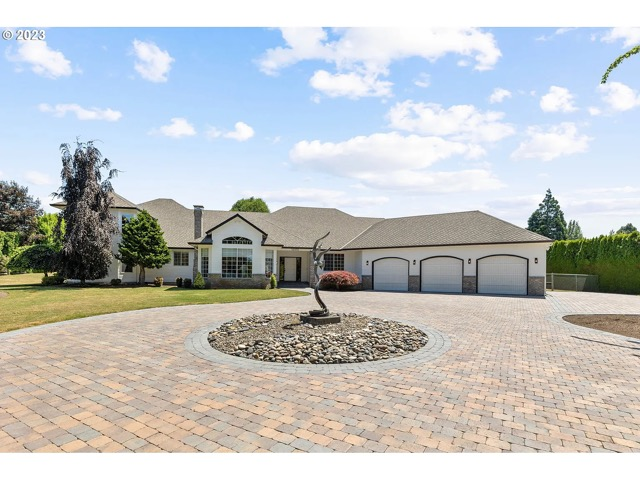 paver-grand-entrance Completed paver driveway, circular arrival area, and landscaped front entry