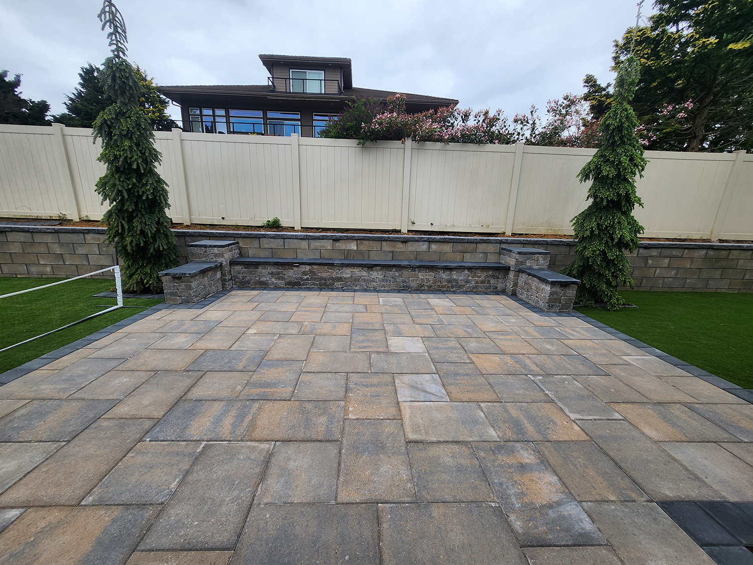 paver-patio-retaining-wall-1.webp Paver patio coordinated with a retaining wall