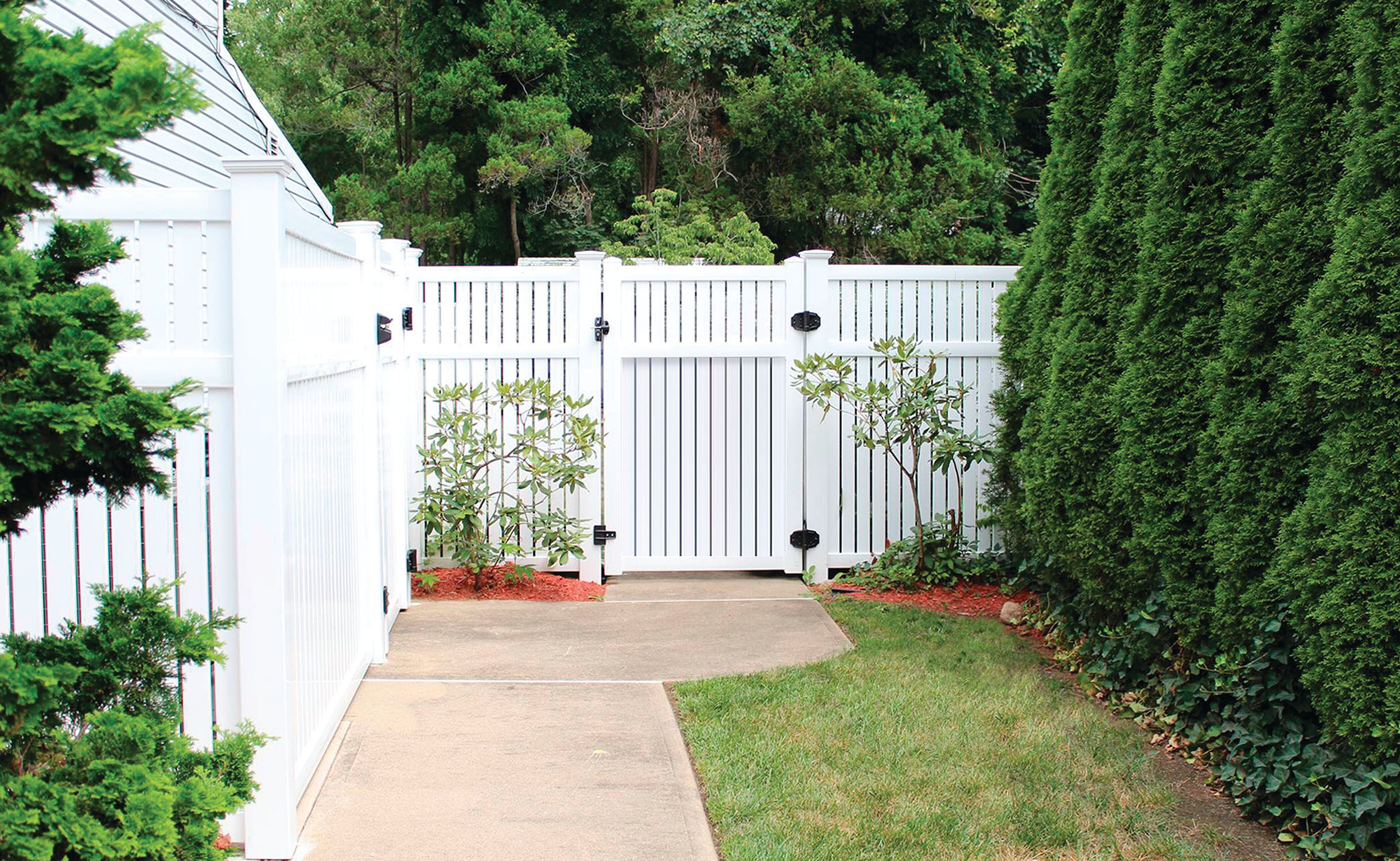 Semi-private fence bordering a landscaped yard